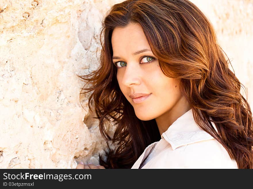 Young woman with curly hair looking at the camera. Young woman with curly hair looking at the camera