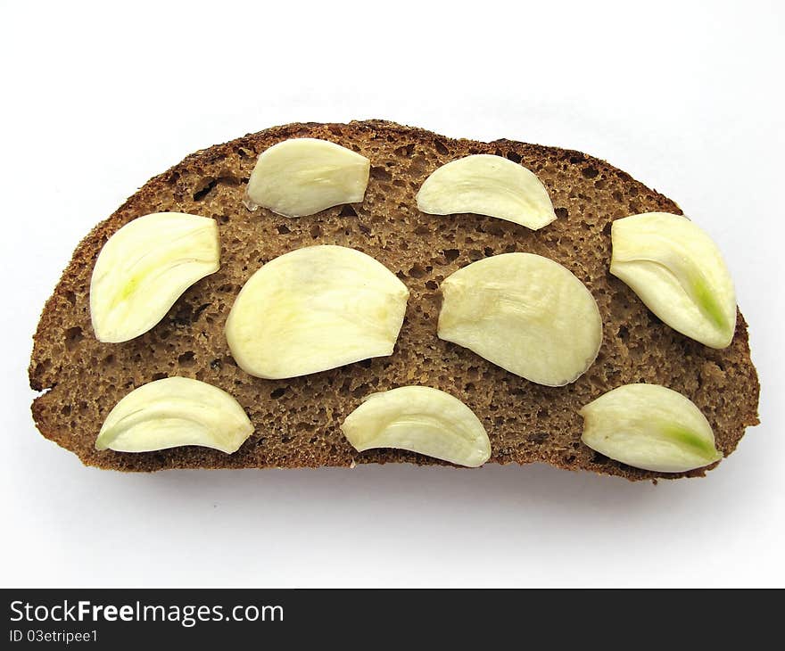 Cut Garlic on brown bread. Cut Garlic on brown bread