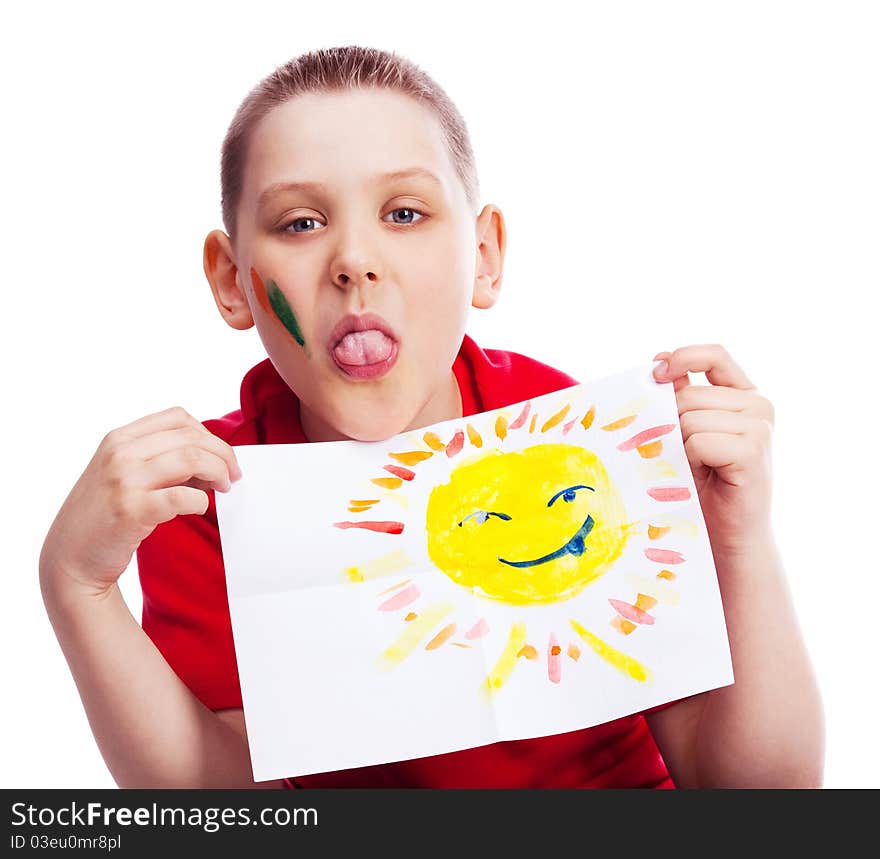 Ten year old boy showing his tongue and holding a watercolor picture of the sun. Ten year old boy showing his tongue and holding a watercolor picture of the sun