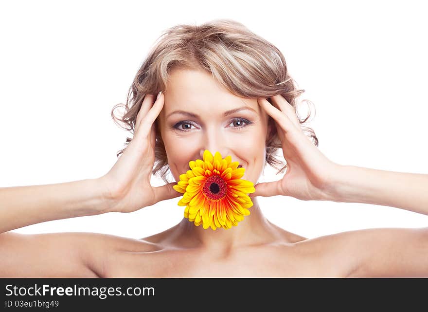 Beautiful young blond curly woman with a flower in her mouth