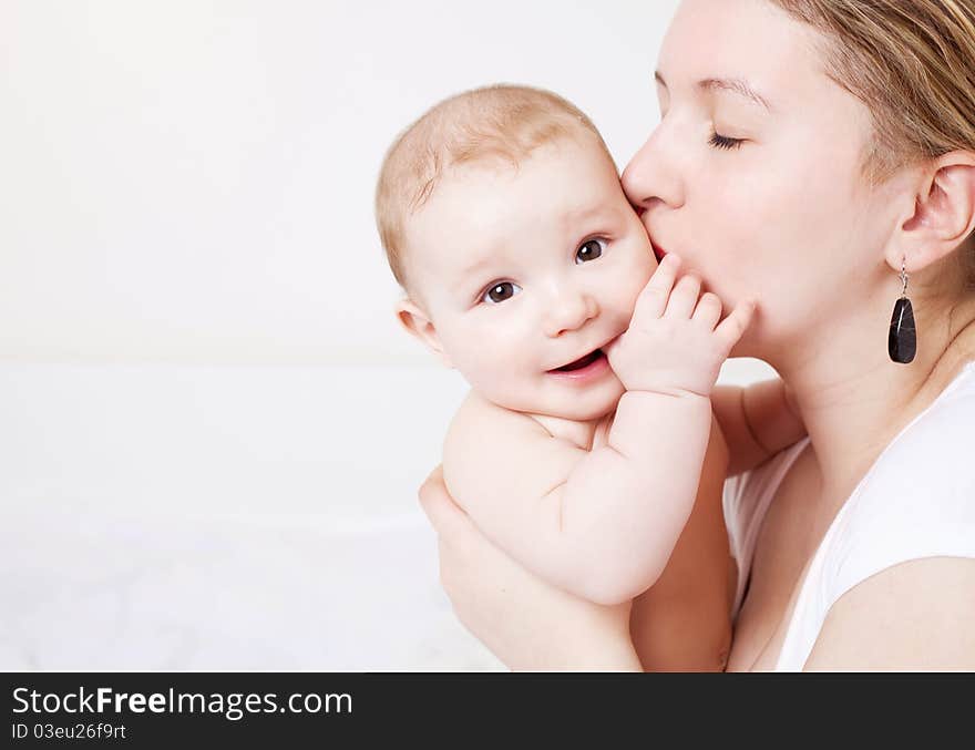 Young mother and her six months old baby at home. Young mother and her six months old baby at home