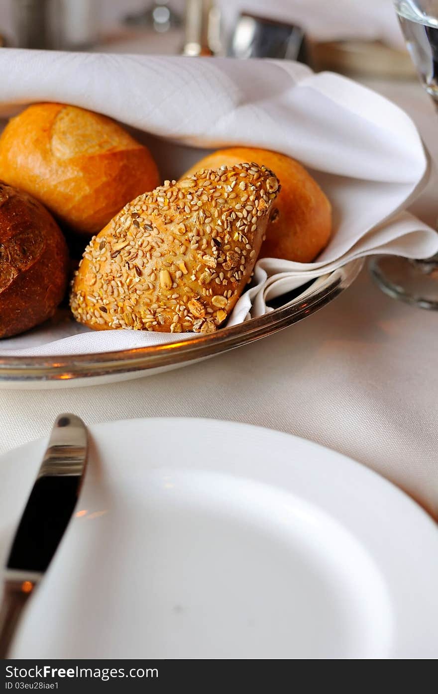 Macro shot of brown bread buns and white kitchenware ready to eat. Macro shot of brown bread buns and white kitchenware ready to eat.