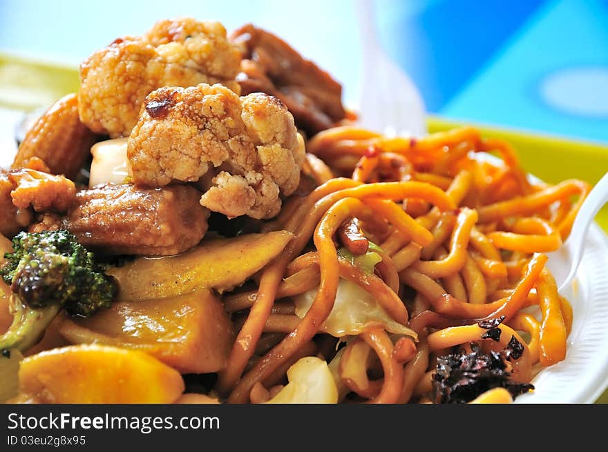 Oriental style vegetarian fried noodles topped with healthy vegetables. Oriental style vegetarian fried noodles topped with healthy vegetables.