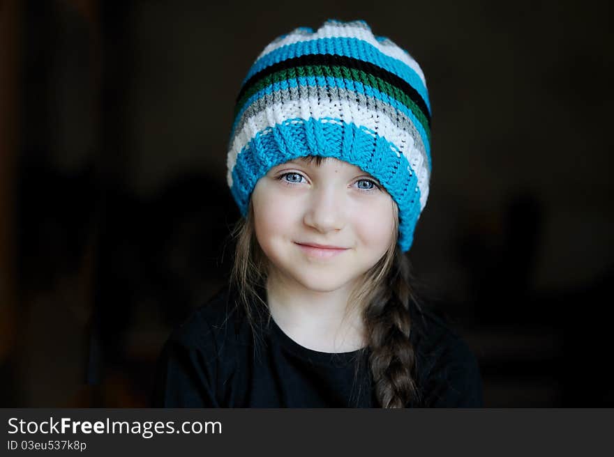 Cutelittle girl in knit blue, grey, white and black stripes on it. Cutelittle girl in knit blue, grey, white and black stripes on it