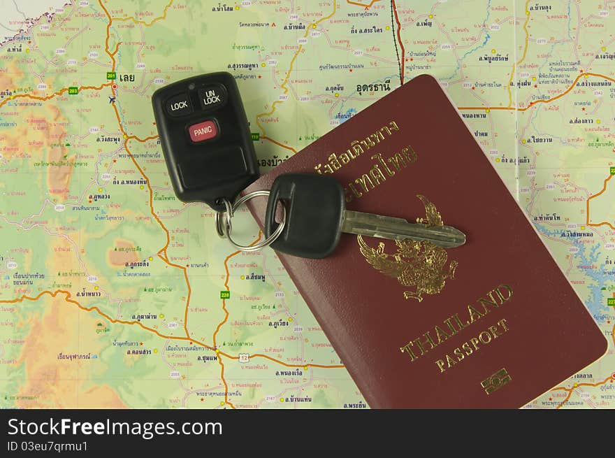 Thailand passport and car key on map