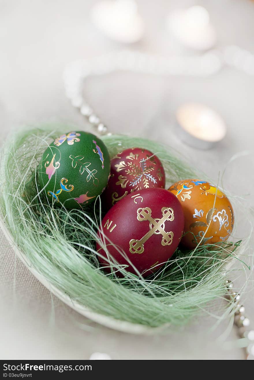 Colored Easter eggs with decoration and candles