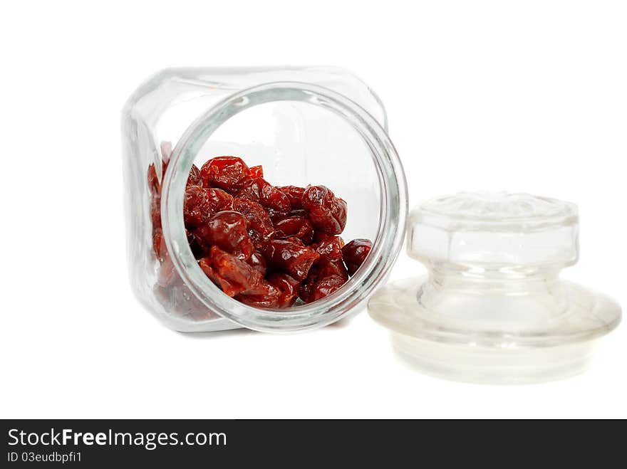 Dry cherry in the glass jar isolated on white background. Dry cherry in the glass jar isolated on white background