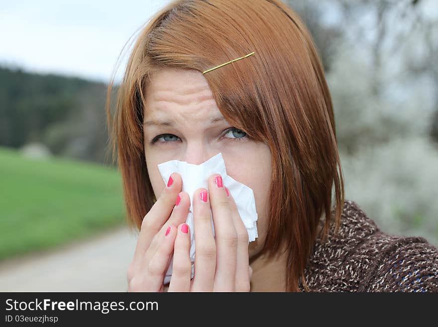 An red haired girl snooting in a handkerchief. An red haired girl snooting in a handkerchief