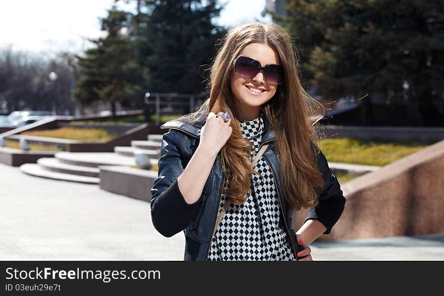 Pretty girl in sunglasses walks