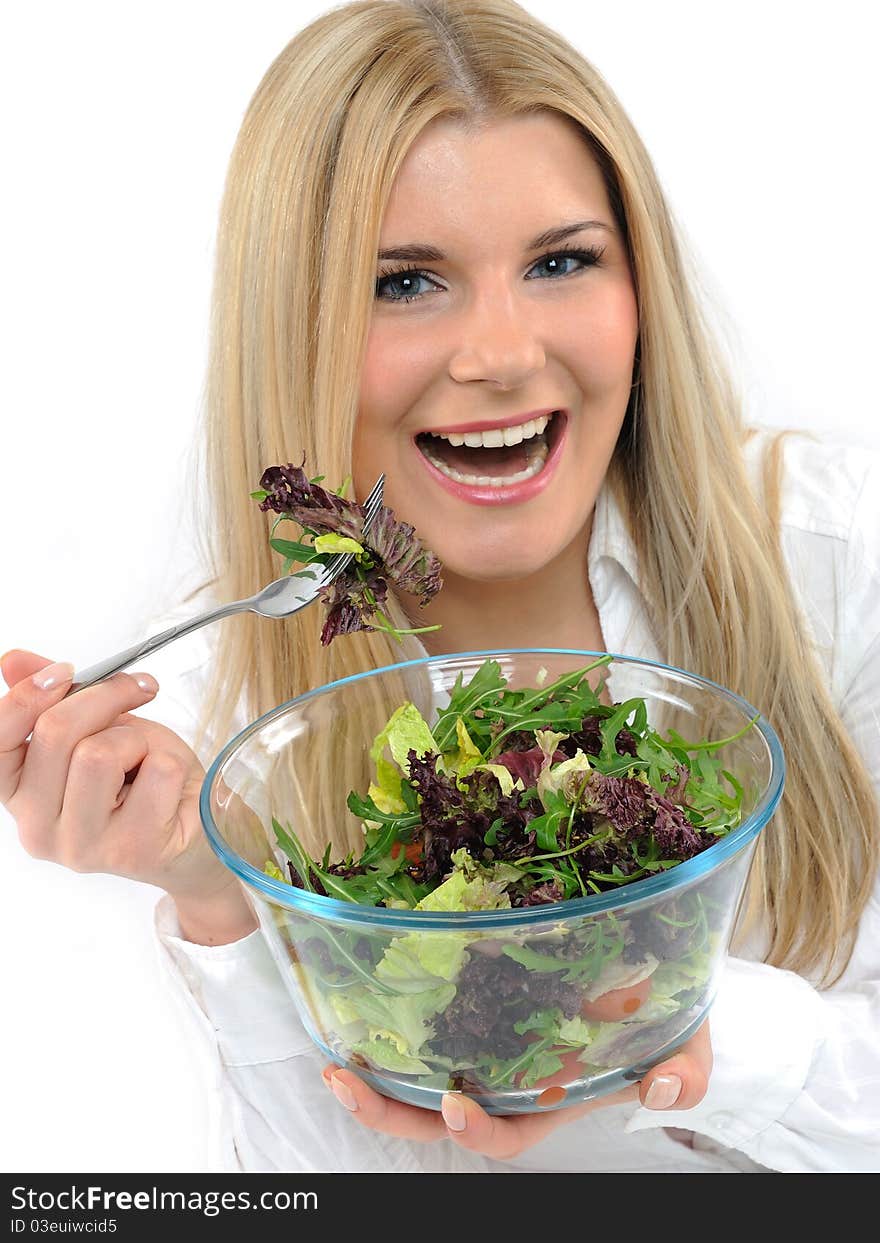 Pretty woman eating green vegetable salad.