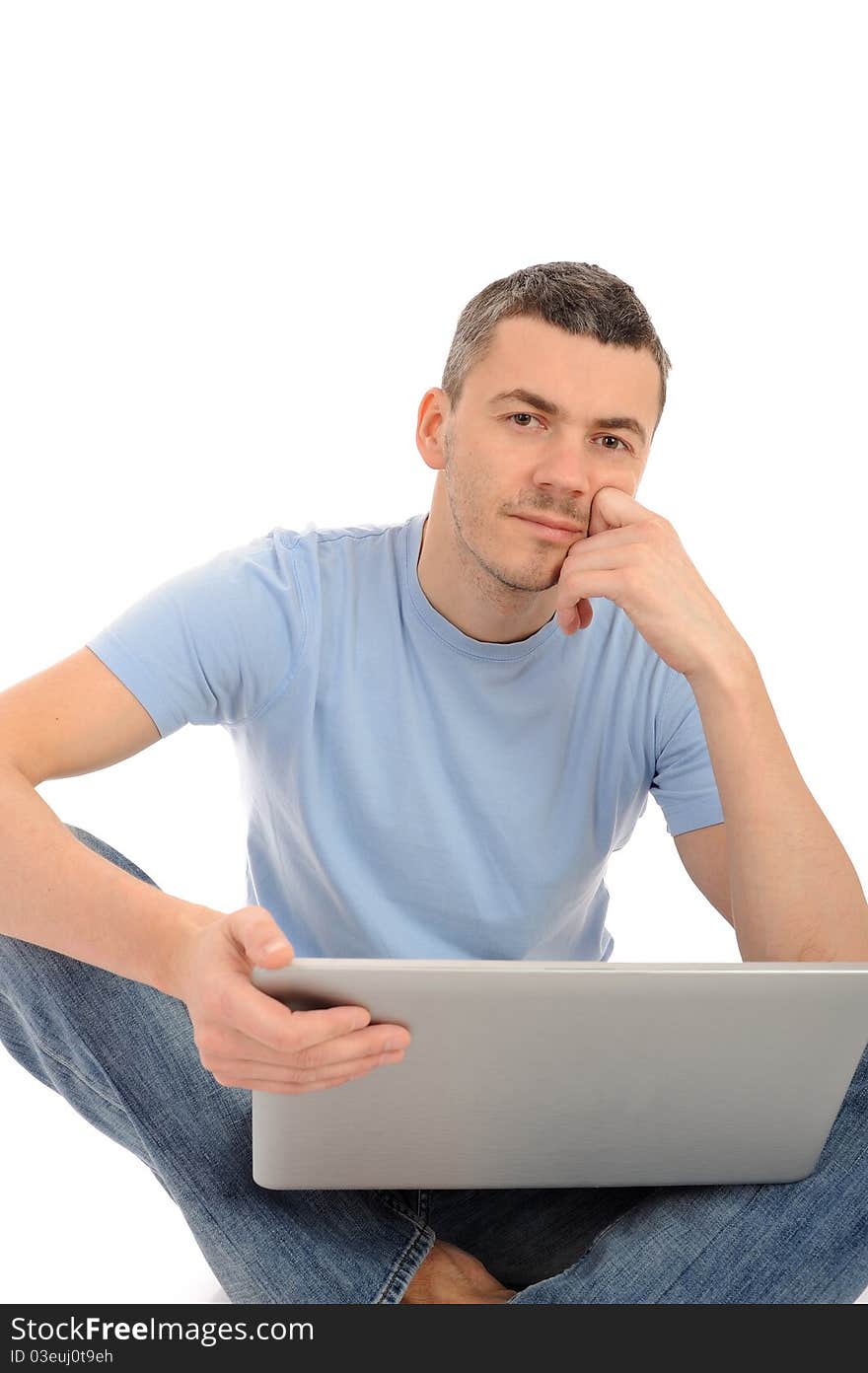 Handsome young male working on laptop computer. isolated