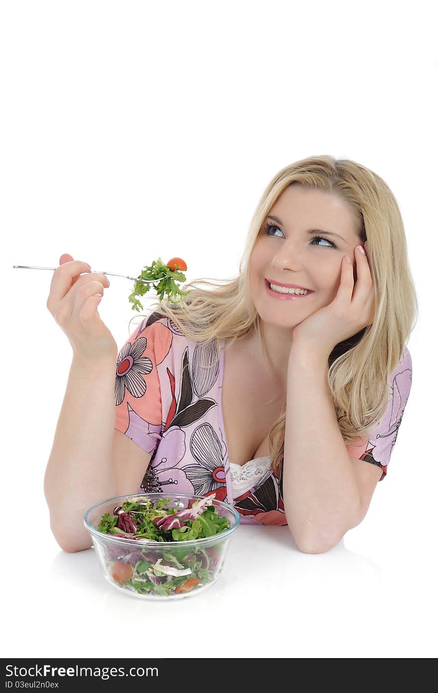 Pretty woman eating green vegetable salad. isolated on white