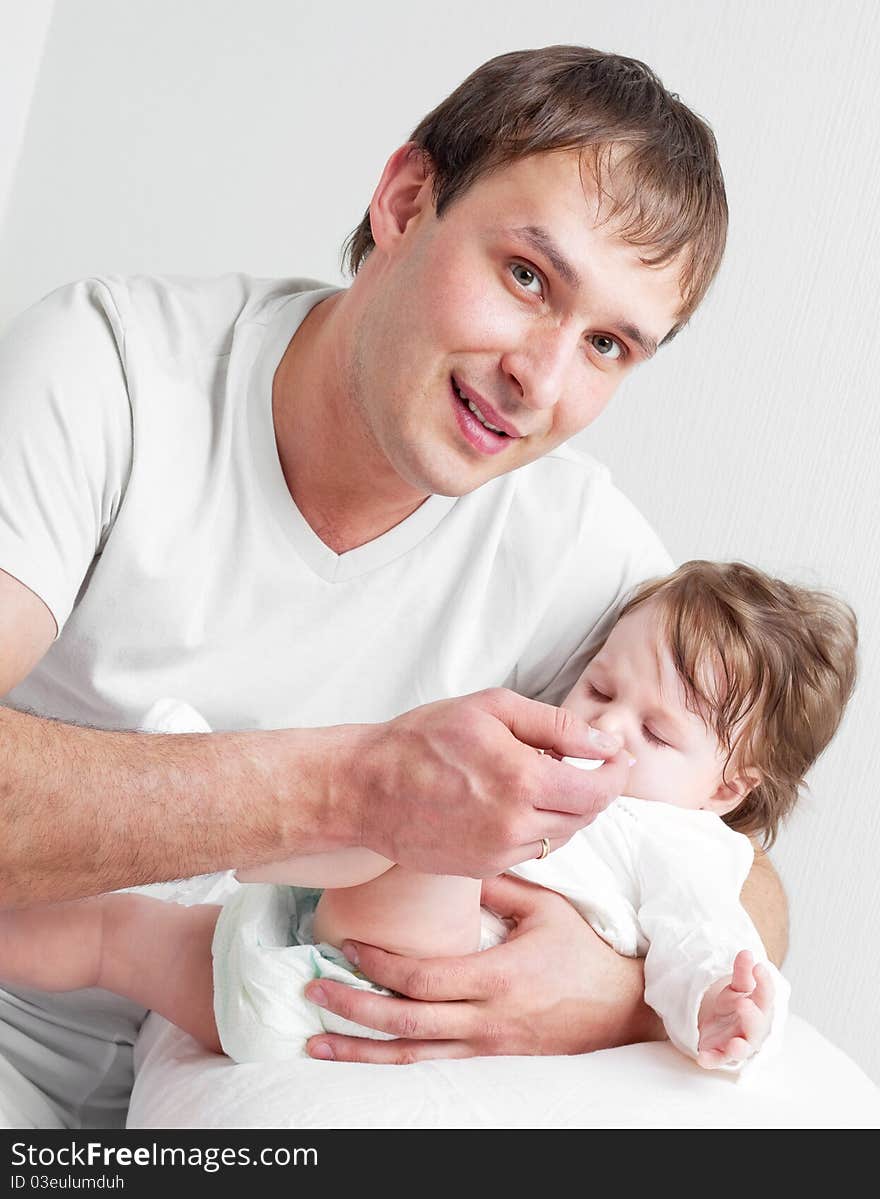 Father feeding daughter