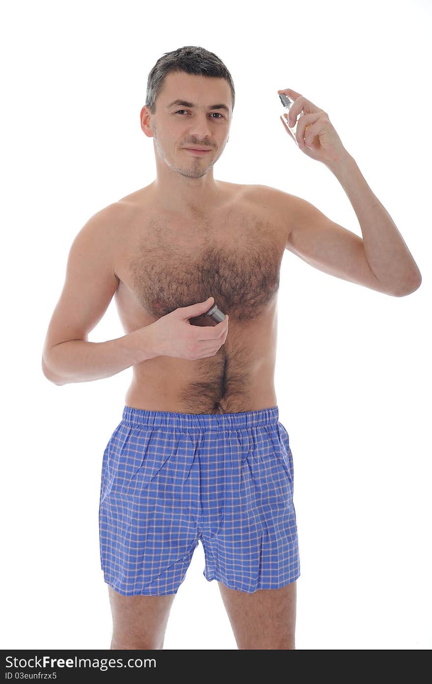 Handsome young male spray perfume on his skin. isolated on white background