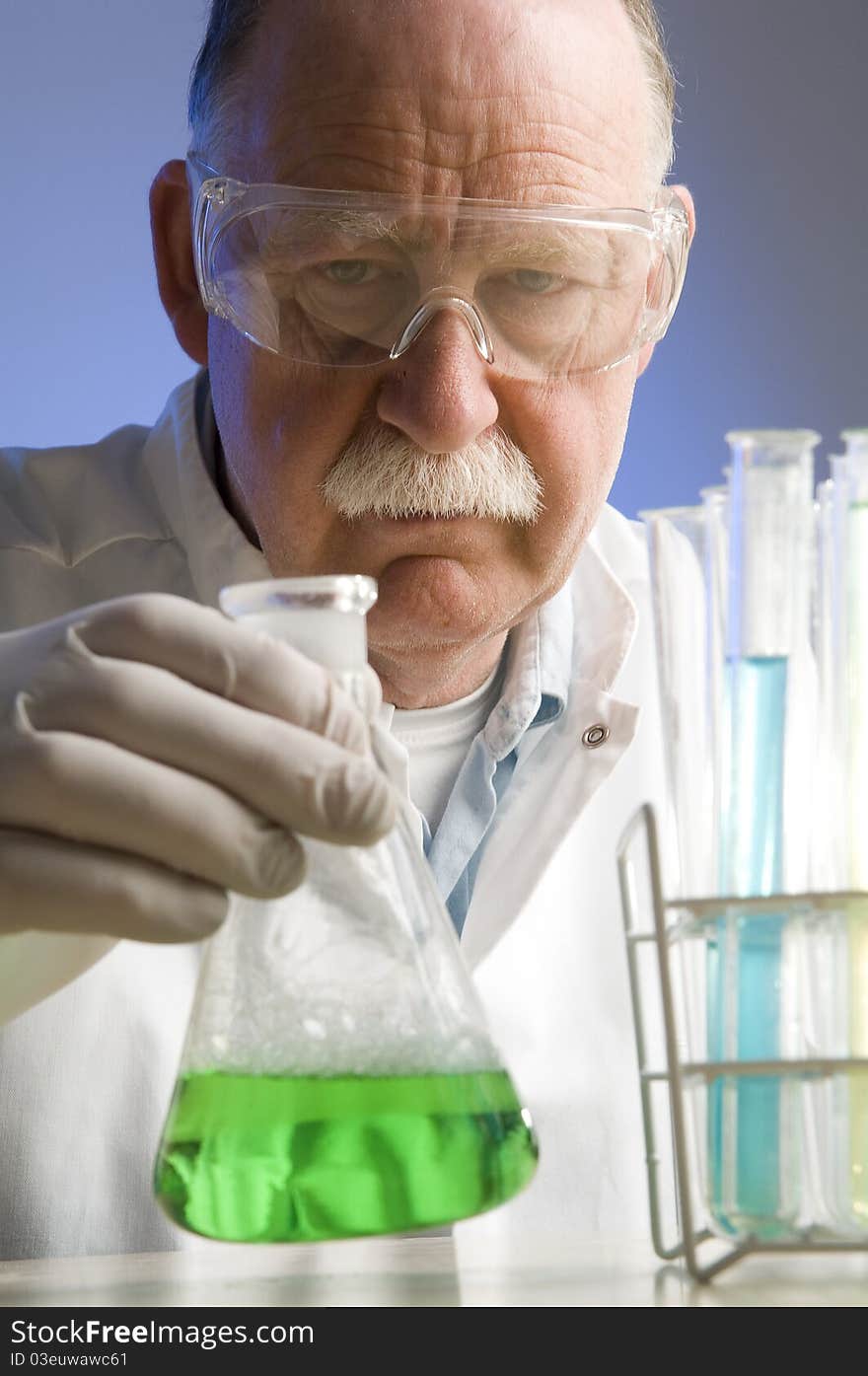 Chemist looking closely at his latest discovery. Chemist looking closely at his latest discovery