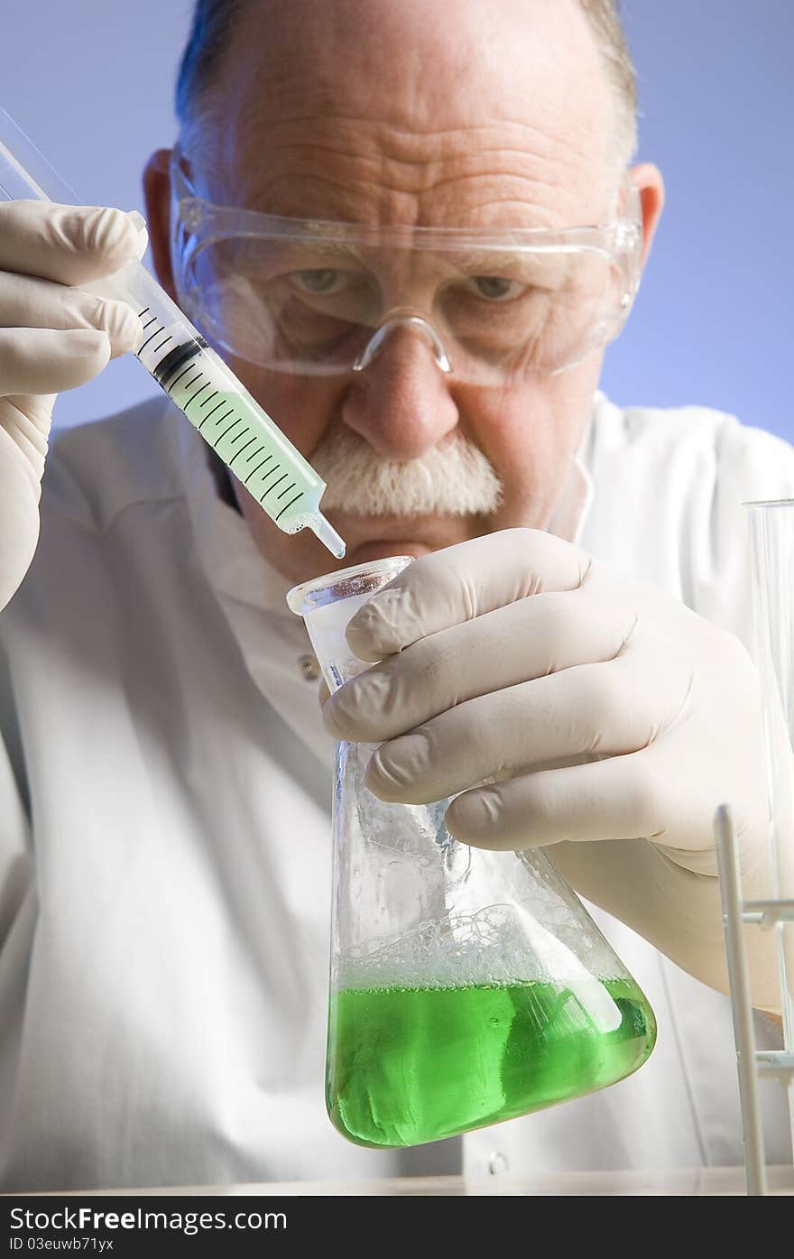 Chemist looking closely at his latest discovery. Chemist looking closely at his latest discovery