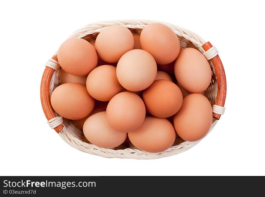 Eggs in basket isolated on white white background