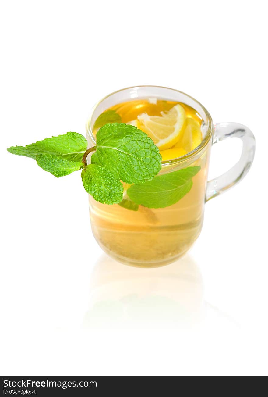 Green tea with lemon and mint in a transparent mug