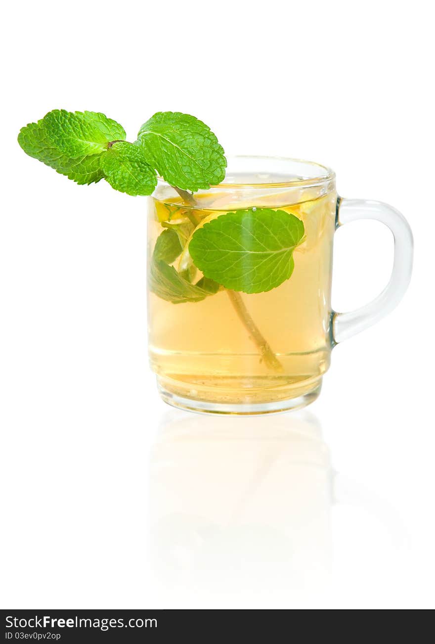 Green tea with lemon and mint in a transparent mug