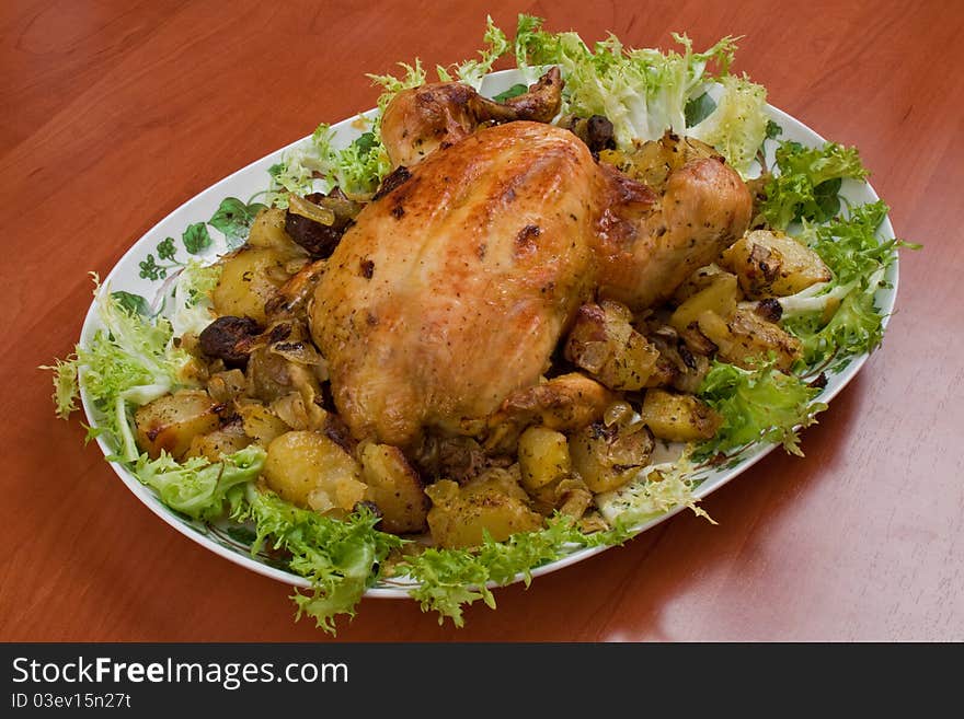 A dish of chicken with salad on the kitchen table. A dish of chicken with salad on the kitchen table