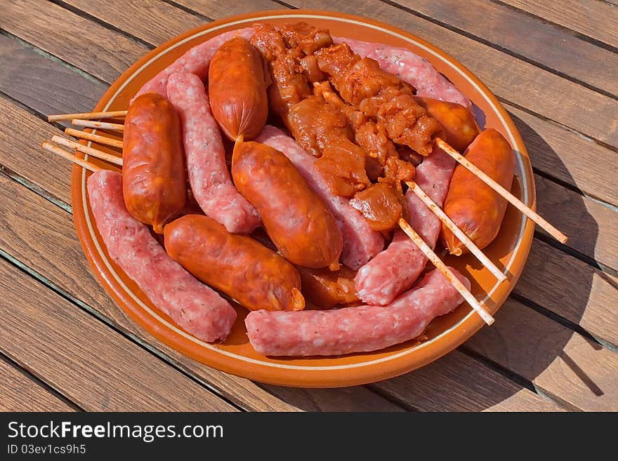 Assorted meat prepared for cooking on the grill on a summer day. Assorted meat prepared for cooking on the grill on a summer day