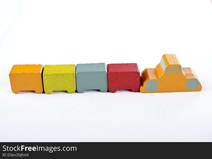 Some wooden toy cars on white