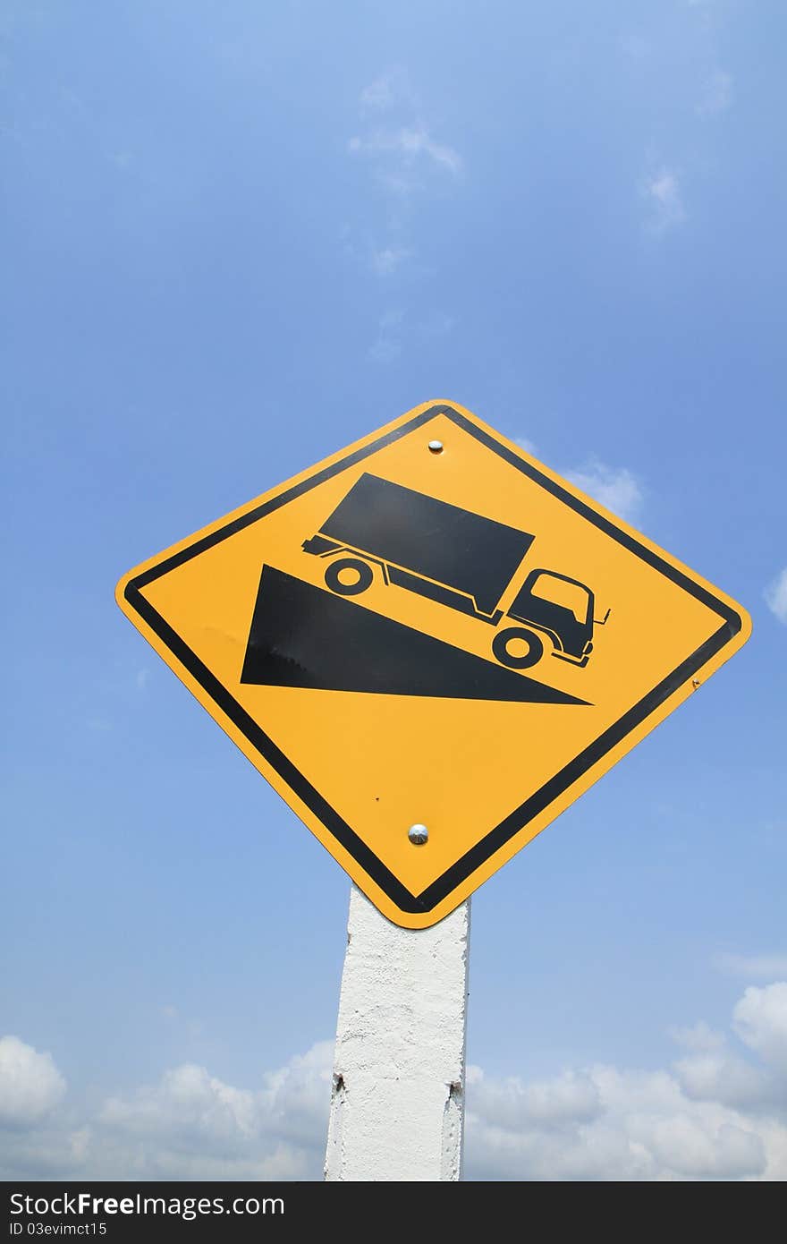 Downhill truck sign on blue sky background