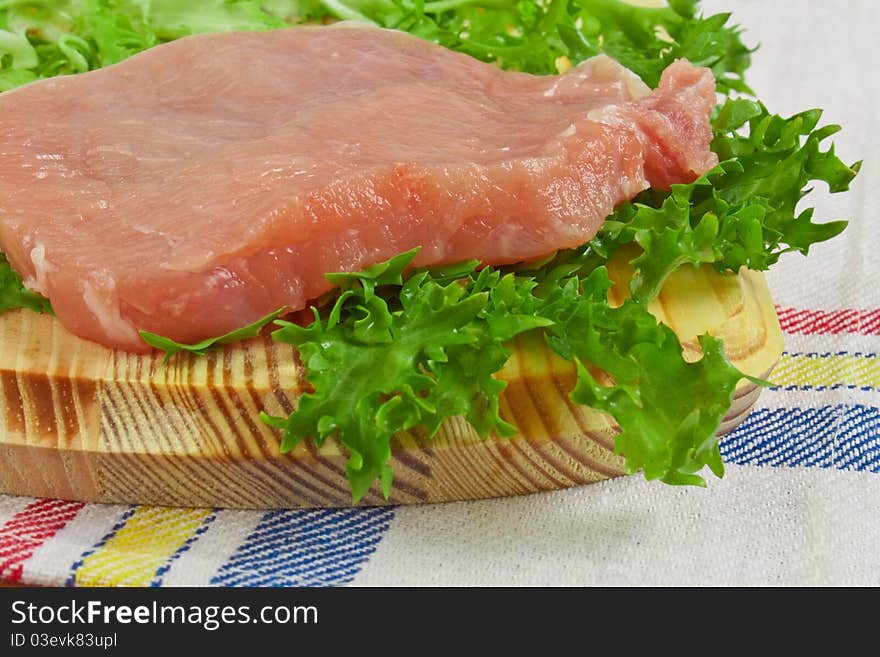 Fresh pork meat on a cutting board, fillet cooking