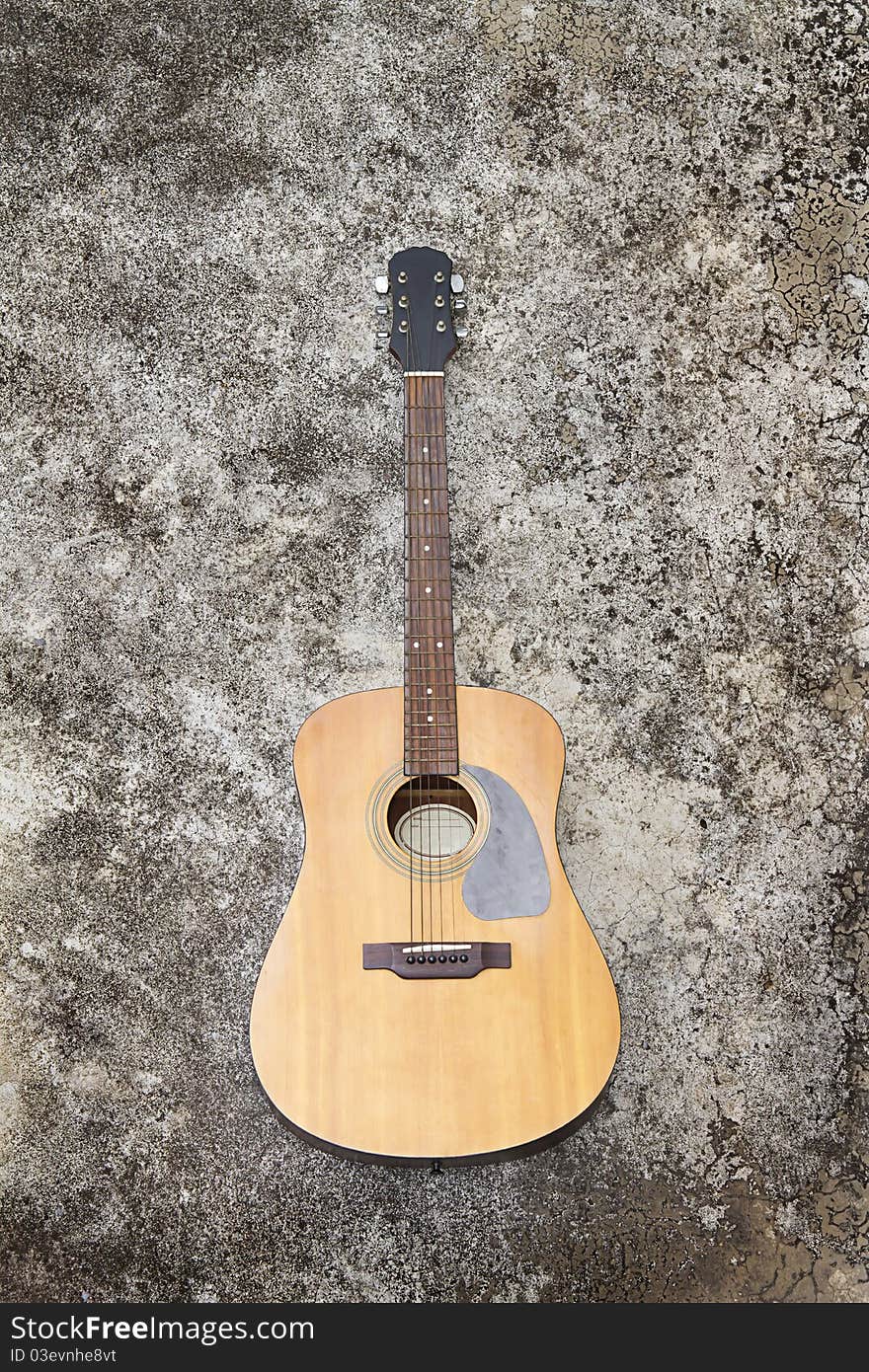 Spanish guitar on old cement floor