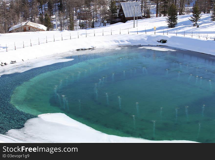 Beautiful artificial lake in the mountain in winter