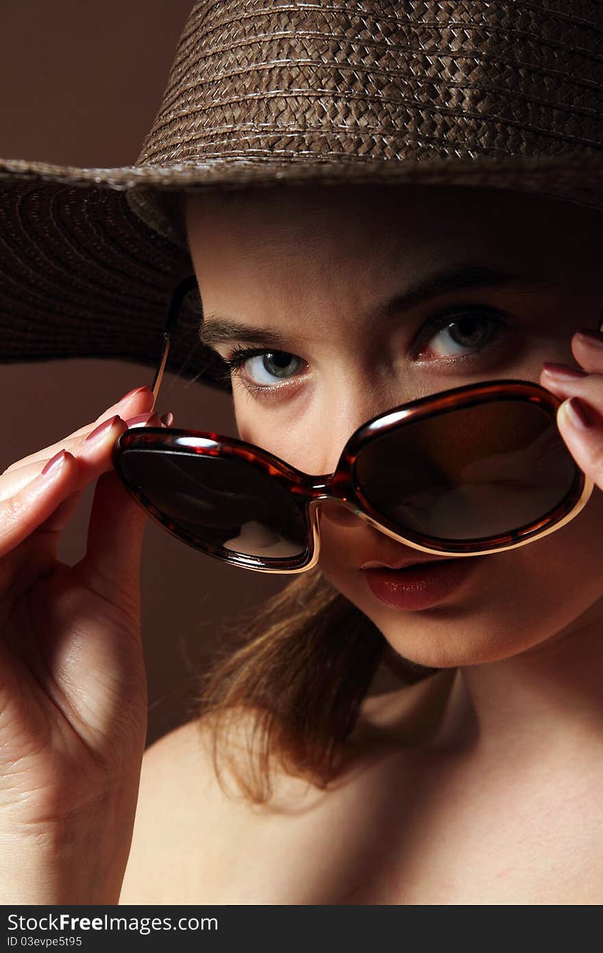 Lady wearing a black straw hat and sunglasses. Lady wearing a black straw hat and sunglasses