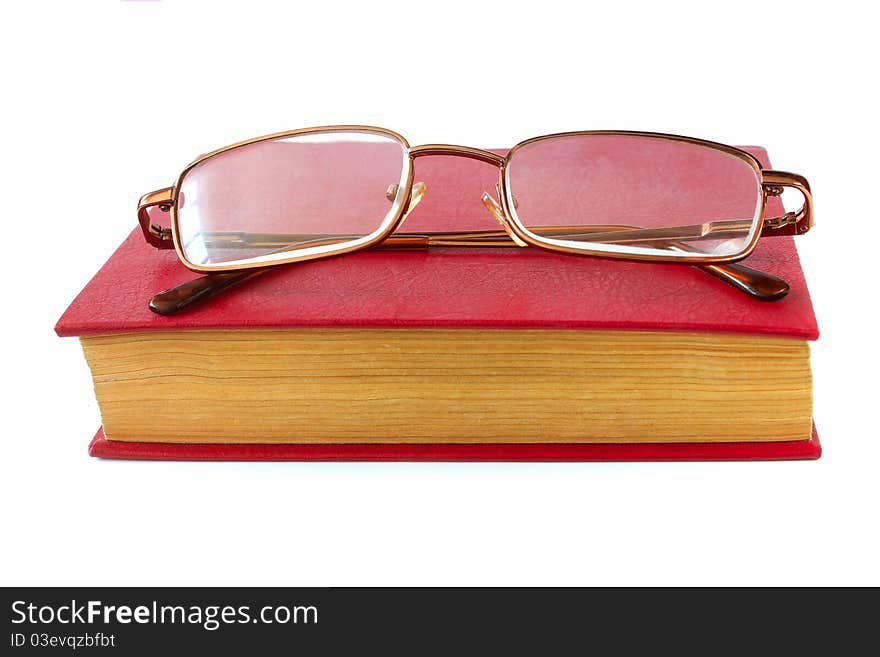 Glasses for vision lie in the book