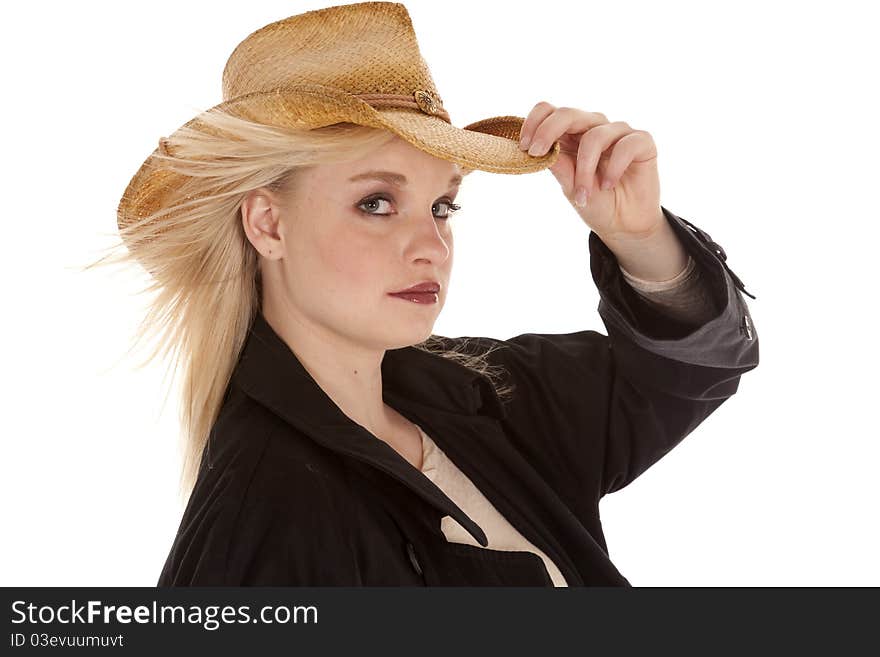 A beautiful cowgirl in her jacket and cowboy hat with a serious expression on her face. A beautiful cowgirl in her jacket and cowboy hat with a serious expression on her face.