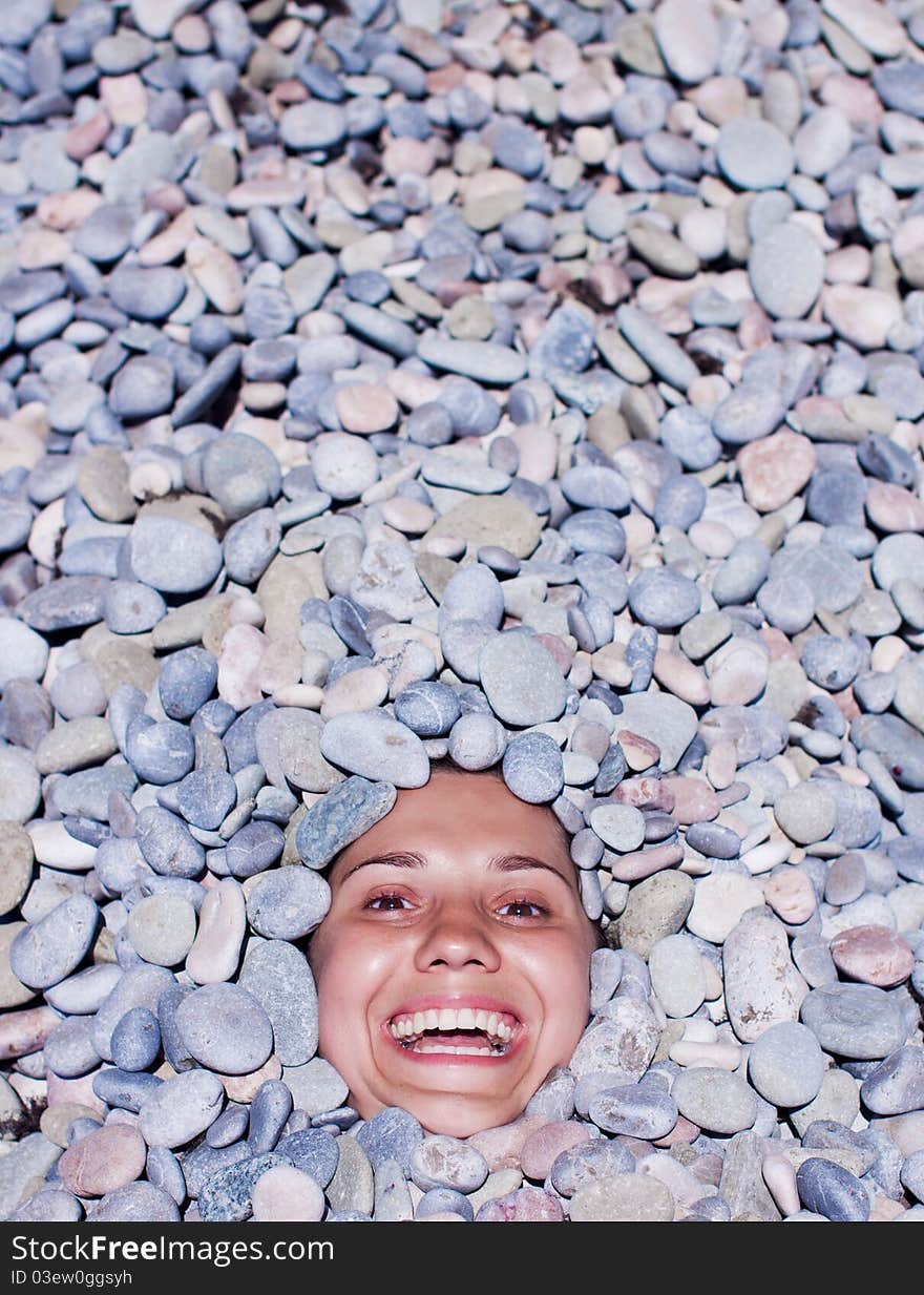 Funny happy girl in stones. Funny happy girl in stones