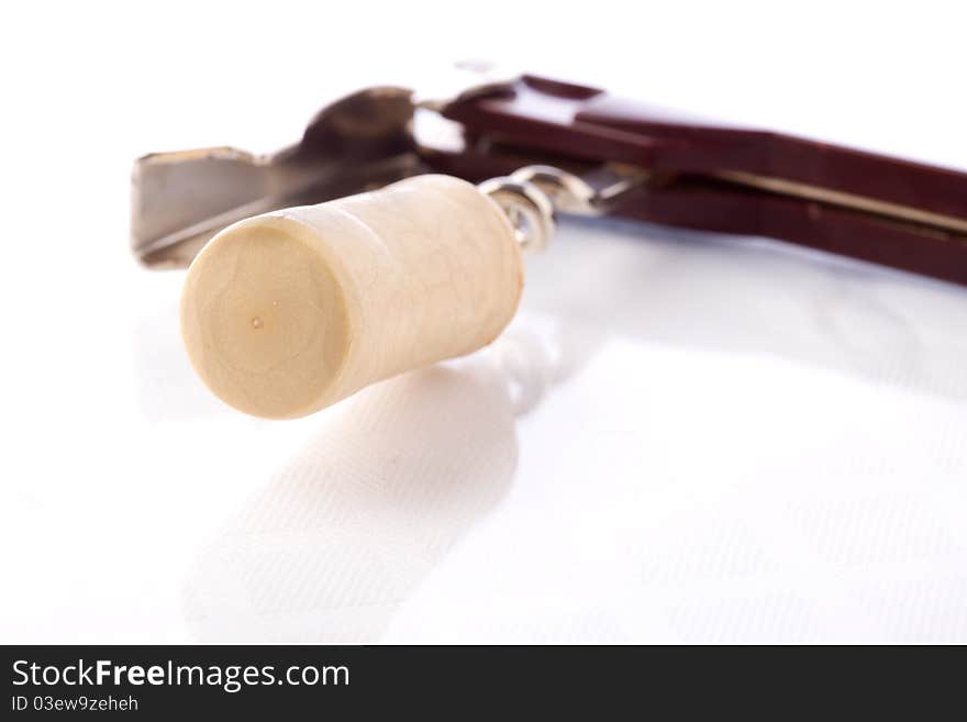 Photo of bottle opener with cork on white isolated background