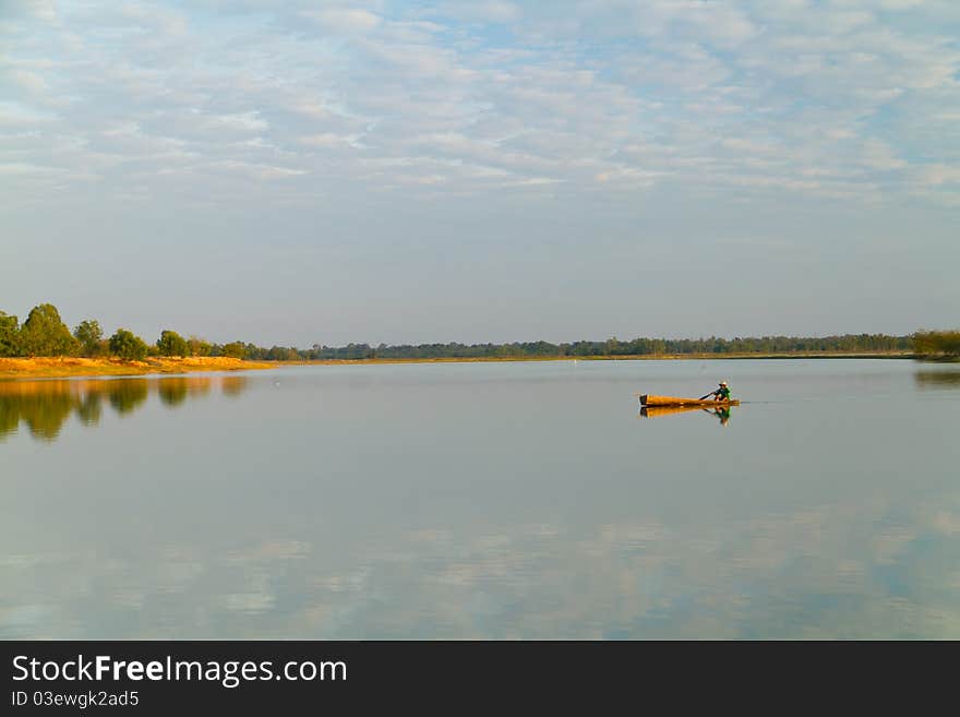 Lonely man in a boat propelled by oar. Lonely man in a boat propelled by oar