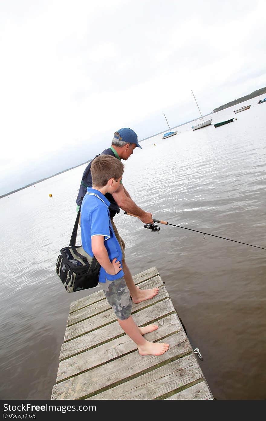 Father and son fishing in lake. Father and son fishing in lake