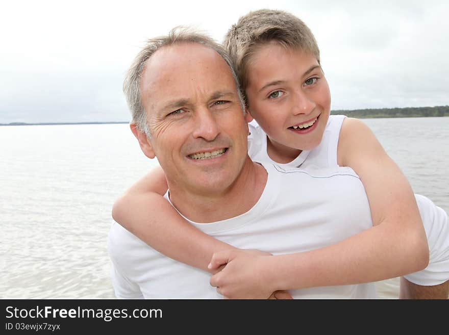 Portrait of men carrying young boy on his back. Portrait of men carrying young boy on his back