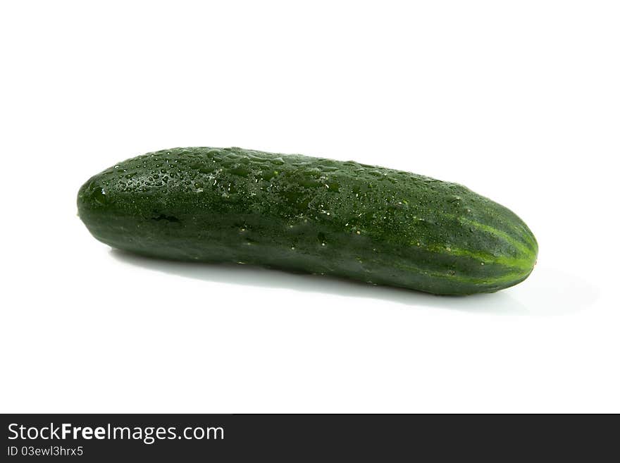 A single green isolated cucumber with shadow. A single green isolated cucumber with shadow.