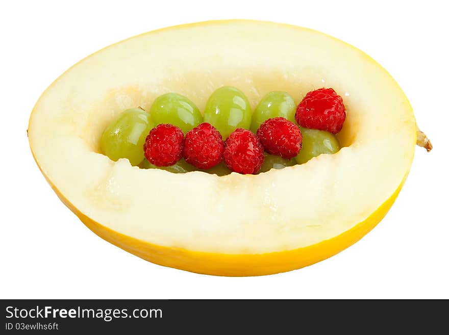 A Honeydew Melone filled with a bunch of grape.