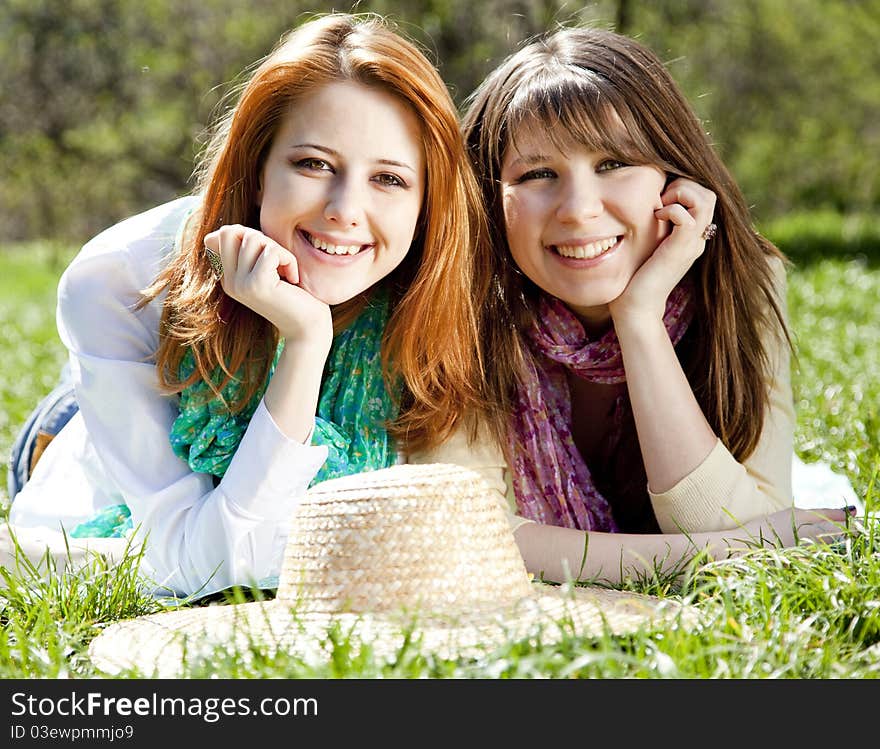 Girlfriends at green grass in the park.