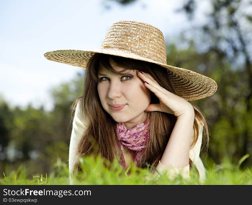 Beautiful brunette girl in hat at the park