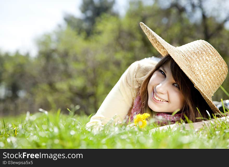 Beautiful brunette girl in hat at the park