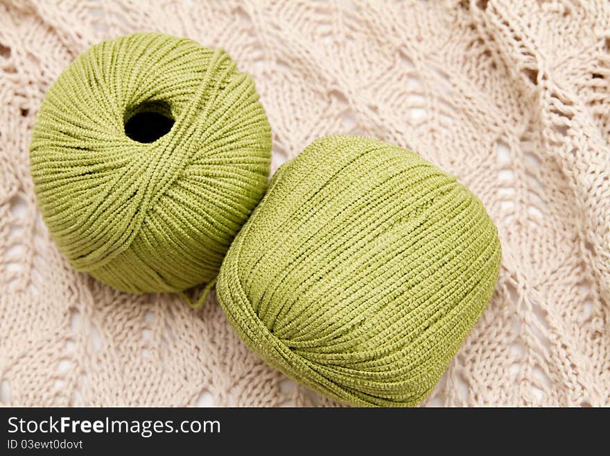 Two green yarn skeins on the cloth