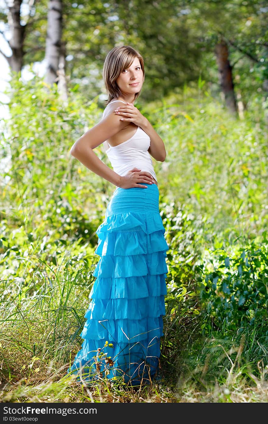 The image of a beautiful girl in a summer forest