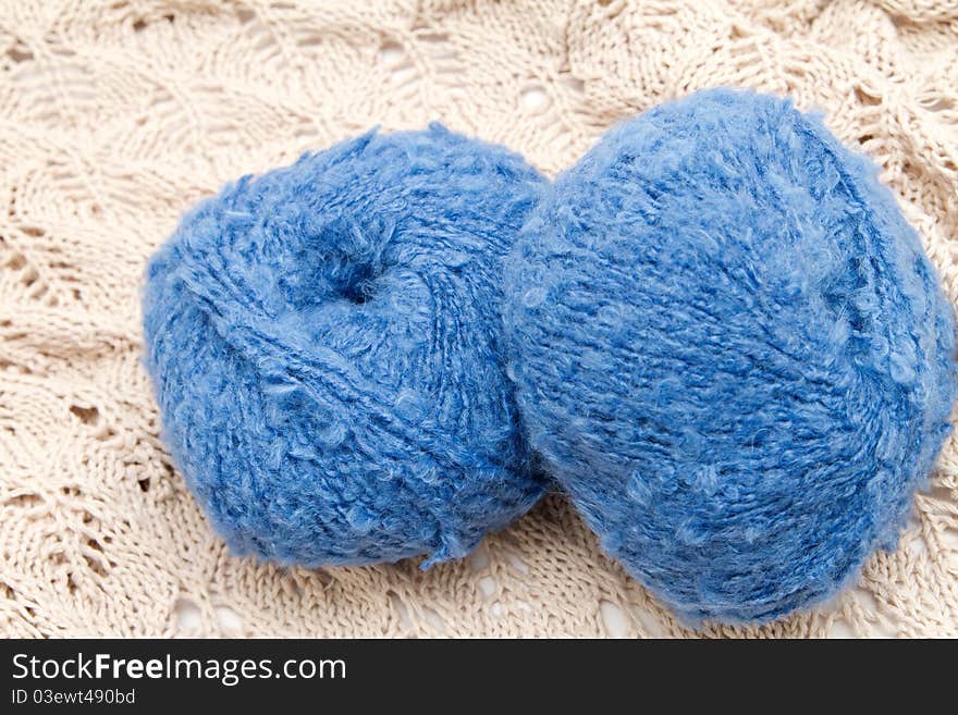 Two blue yarn skeins on the cloth. Two blue yarn skeins on the cloth