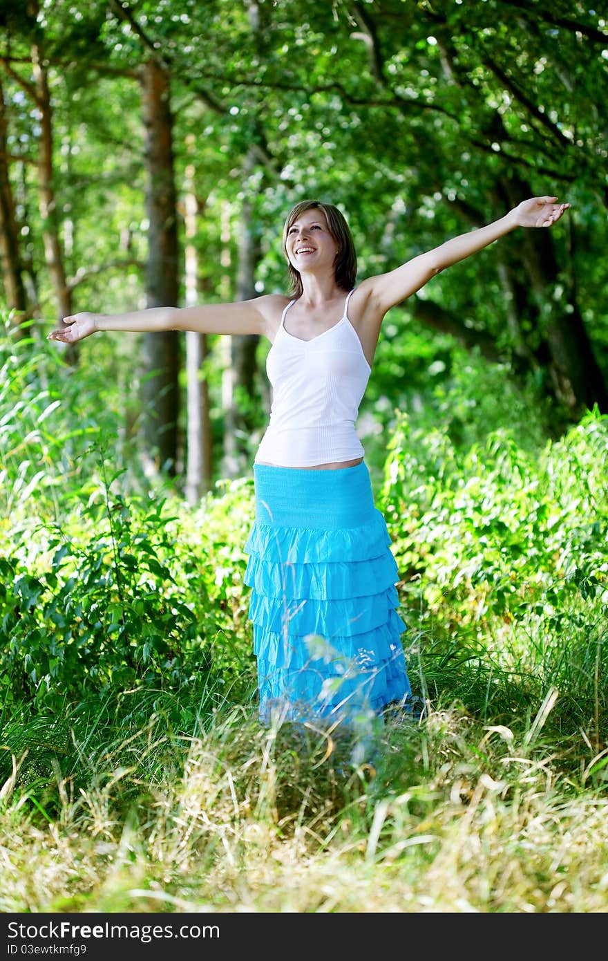 The image of a beautiful girl in a summer forest