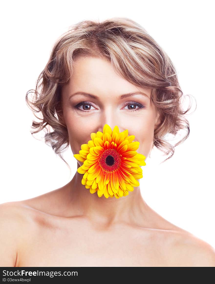 Beautiful young blond curly woman with a flower in her mouth