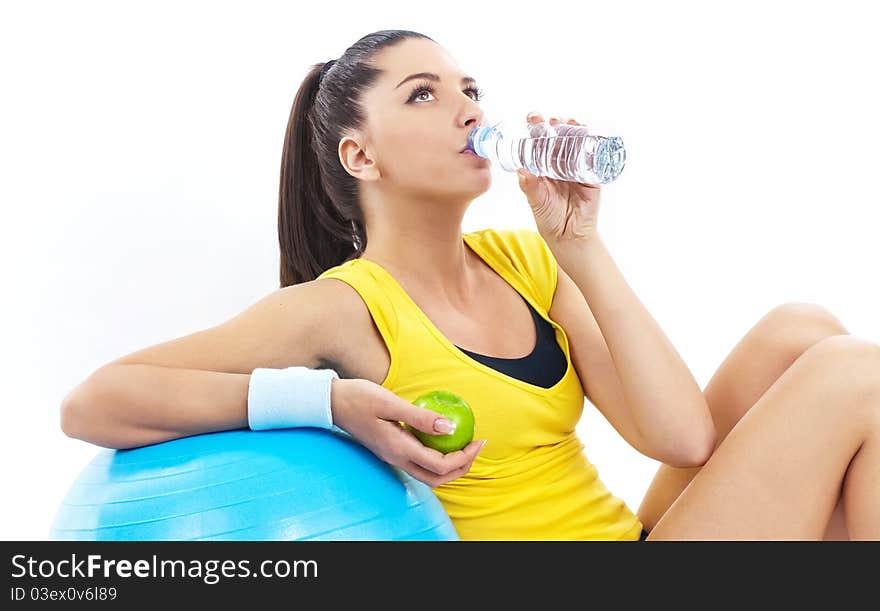 Women drinking water and holding apple. Women drinking water and holding apple