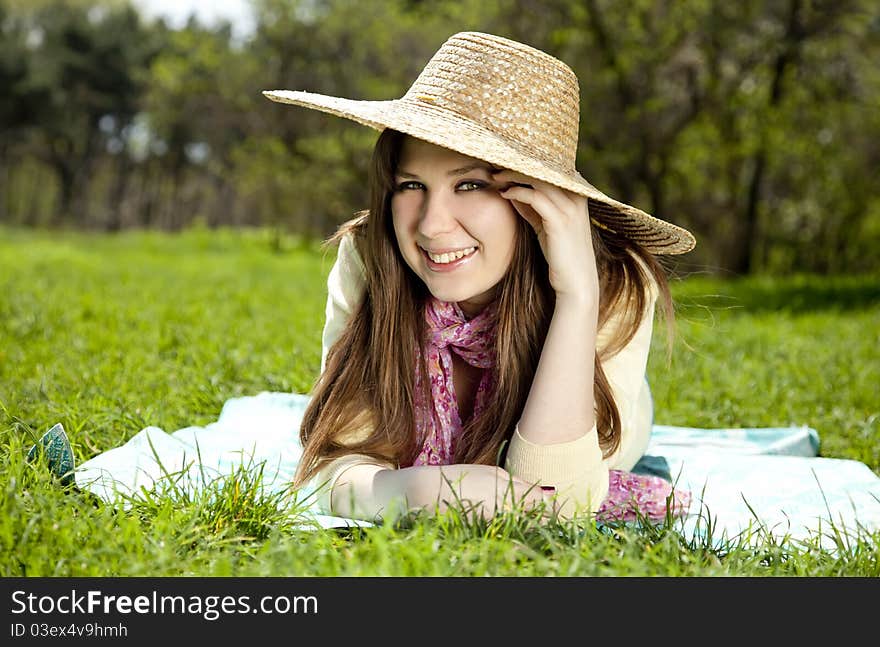 Beautiful brunette girl in hat at the park